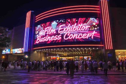 Film exhibitor business concept showing a modern multiplex cinema hall with audience entering for movie screening